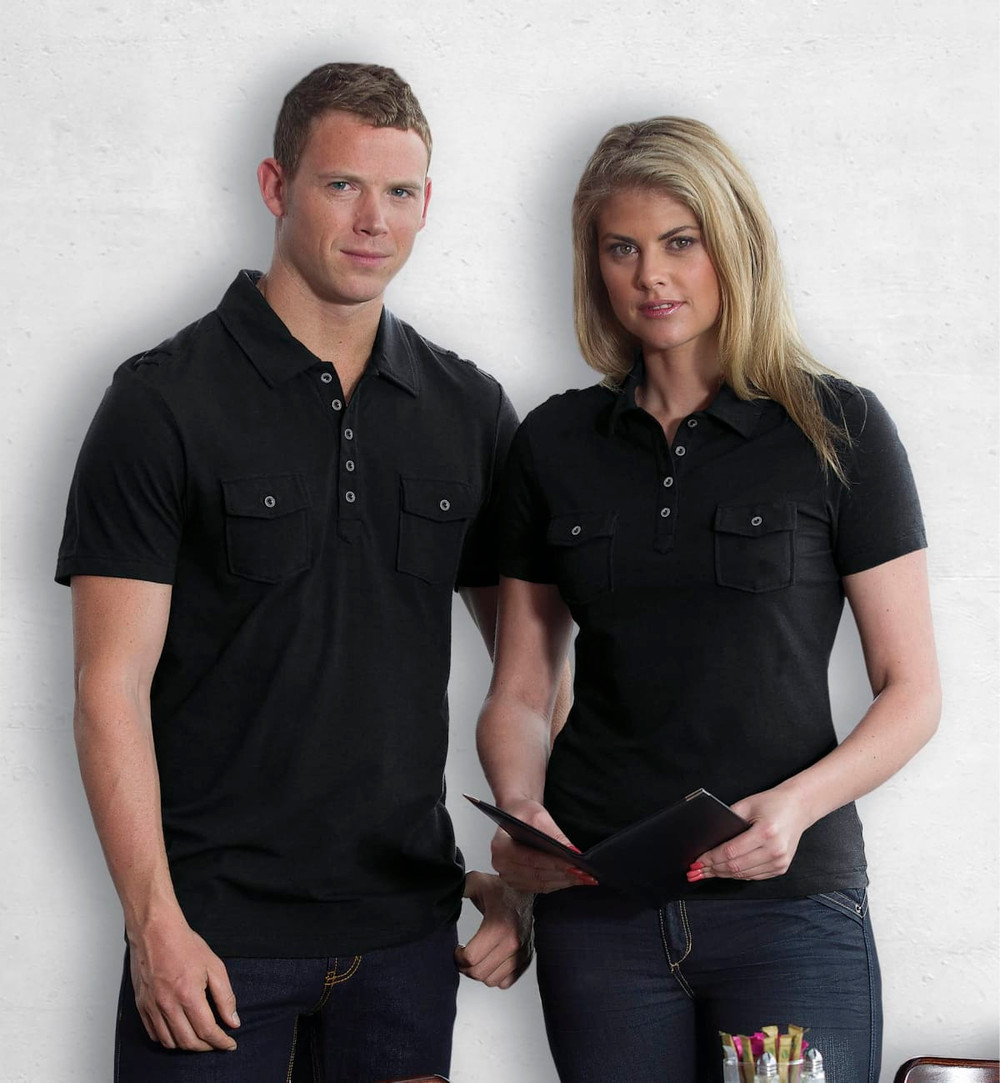 A black women's polo shirt featuring two chest pockets and a classic collar, displayed by a model.