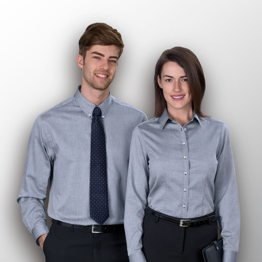 A men's button-up shirt in a grey check pattern, modelled by a man and a woman wearing formal attire.