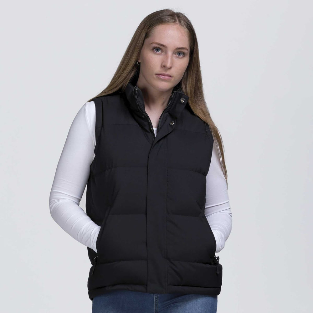 A black puffa vest with a high collar and side pockets, worn by a model against a plain background.