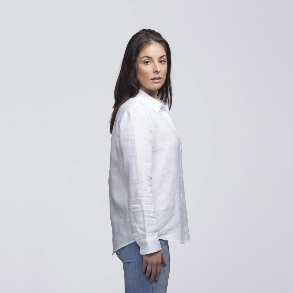A white linen button-up shirt displayed on a model, featuring a relaxed fit and long sleeves.