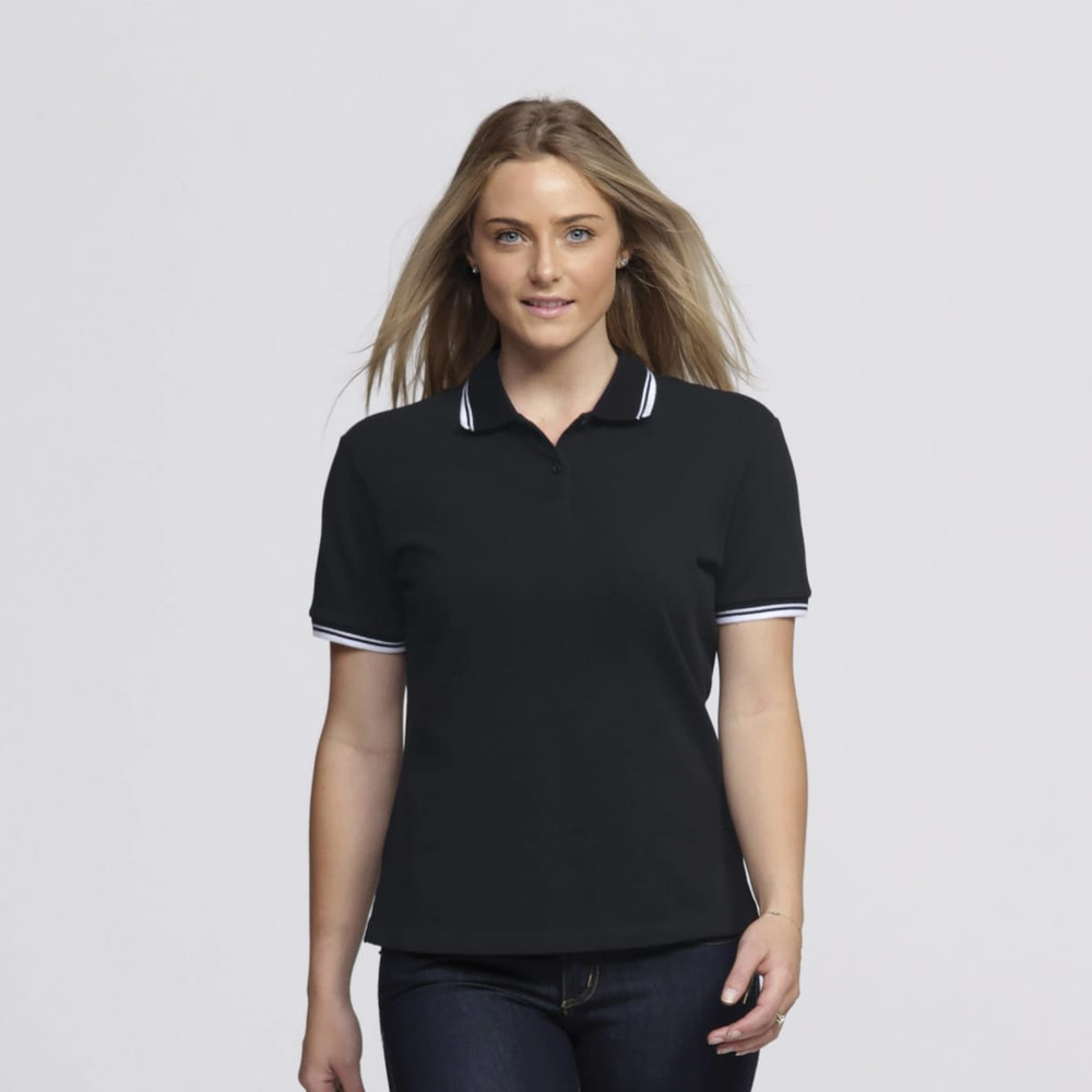 A woman in a black polo shirt with white trim, featuring a logo on the chest. She has long hair styled down.