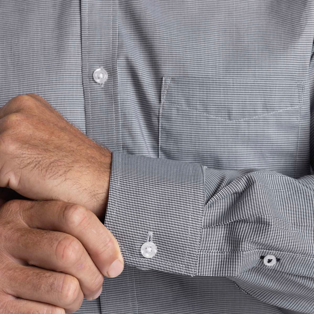 A men's button-up shirt featuring a small check pattern in grey, with a front pocket and buttoned cuffs.
