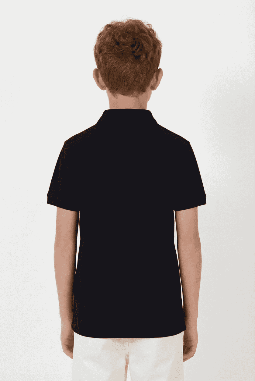 A black youth polo shirt viewed from the back, featuring a collar and short sleeves. The shirt has a logo on it.