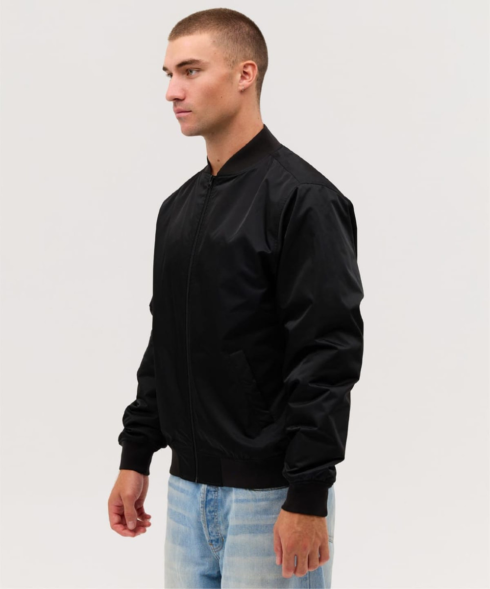 A black bomber jacket with a zip front and ribbed cuffs, shown on a male model against a neutral background.