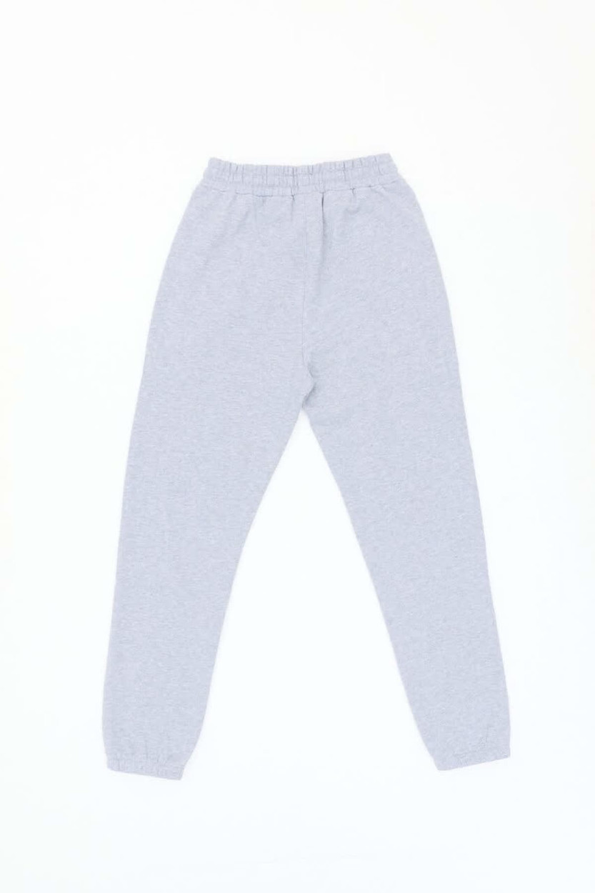 Light grey track pants with an elastic waistband and tapered legs, featuring a small logo.