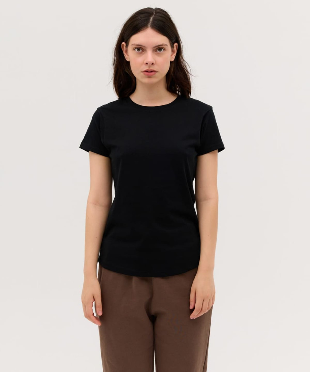 A black women's essential tee, featuring short sleeves and a round neckline, displayed on a model.