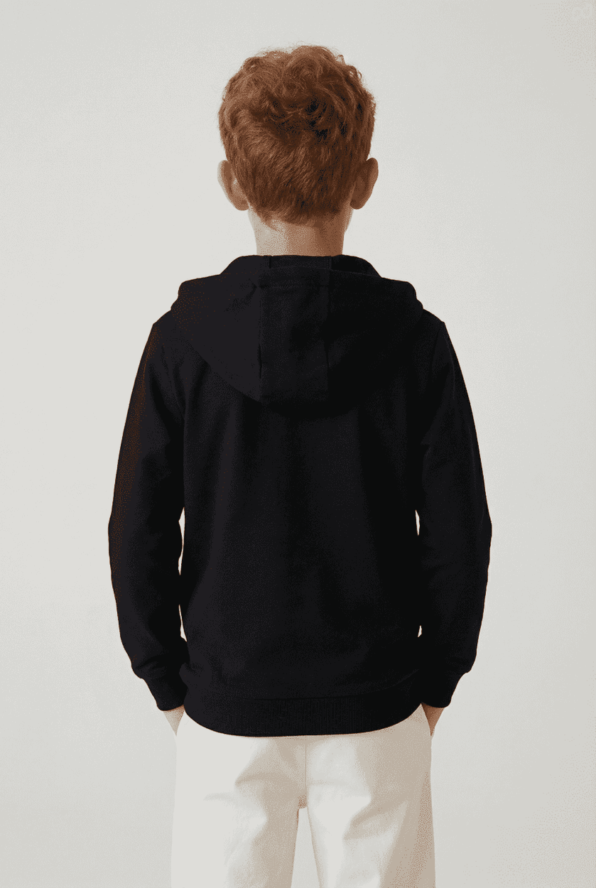 A black hoodie with a zip and a hood, worn by a child viewed from the back. It features a logo on the garment.
