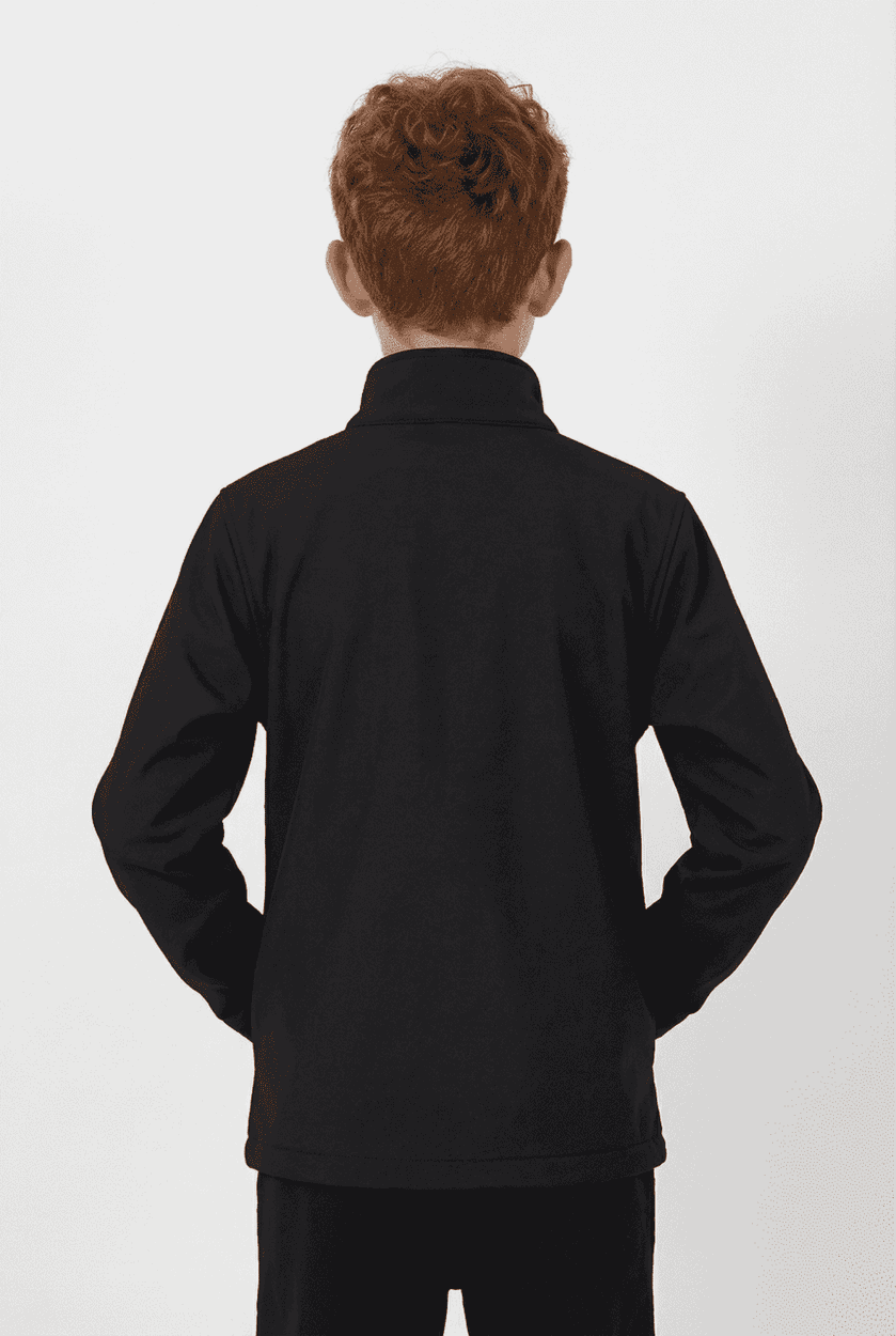 A black softshell jacket for youth, featuring a high collar and long sleeves. It has a logo on the back.