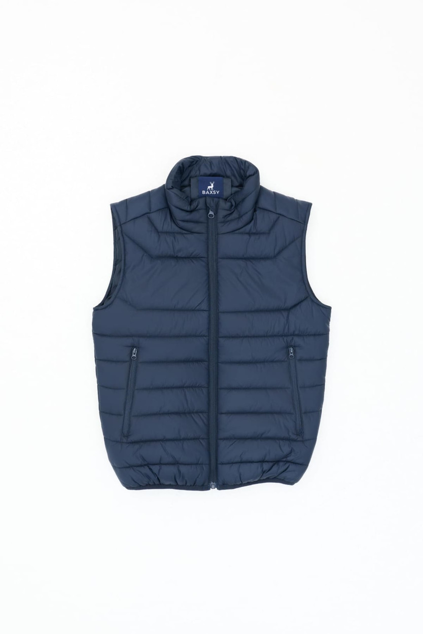 A navy blue puffer vest featuring a high collar, zip front, and two side pockets. It has a logo on the upper side.