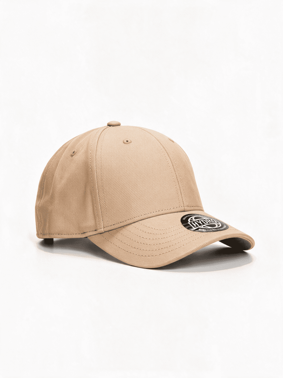 A beige baseball cap featuring a curved brim and a logo on the front. The cap has a soft brushed twill texture.