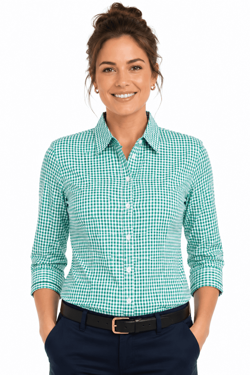 A long sleeve button-up shirt in a green and white check pattern, featuring a collar and a logo.