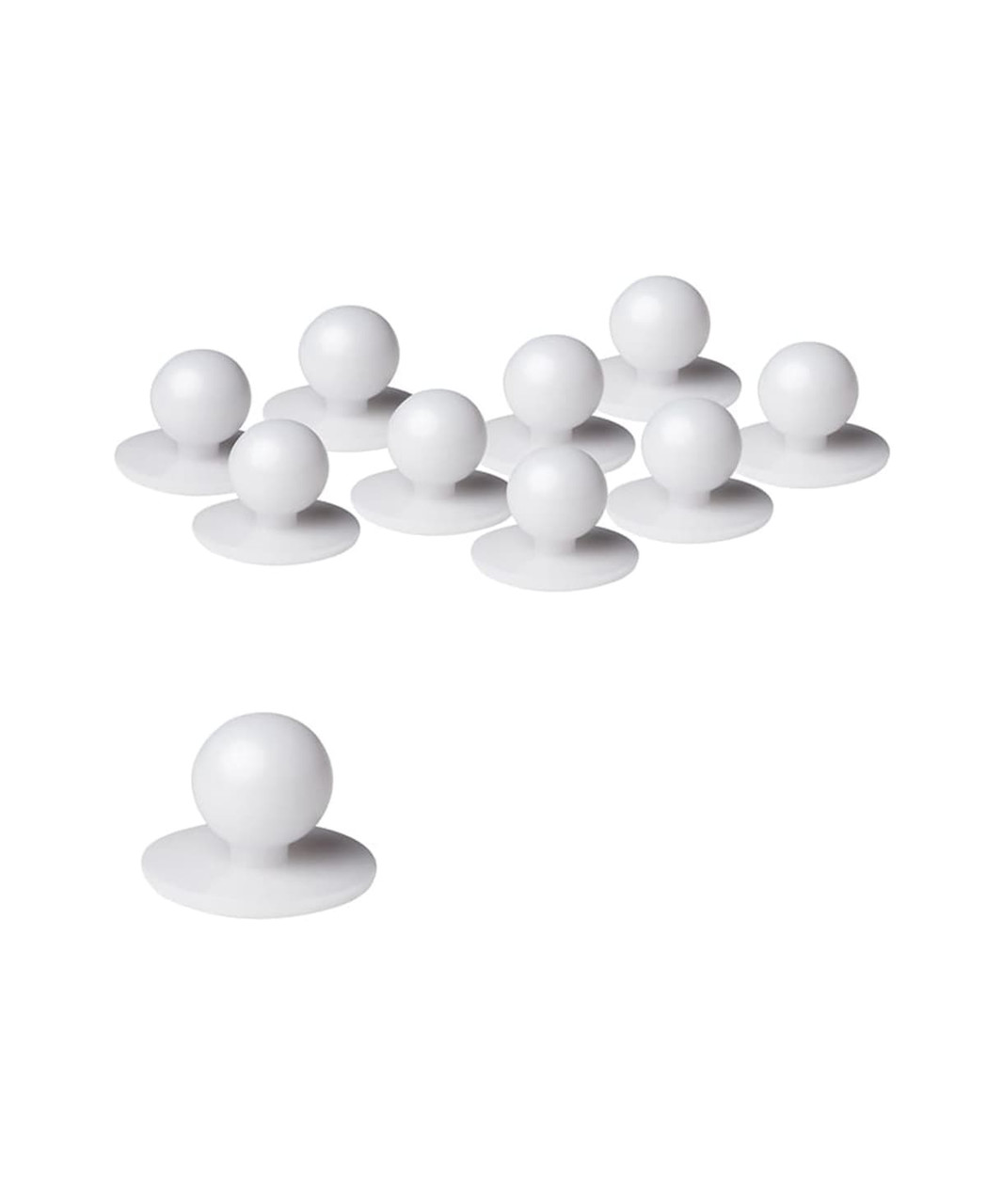 A set of white chef's buttons in various positions, featuring round tops and flat bases.
