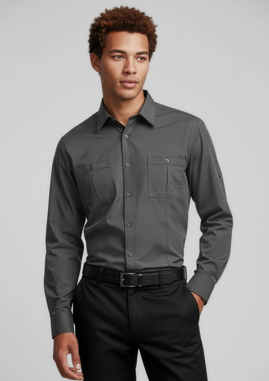 A long sleeve button-up shirt in dark grey, featuring two chest pockets and a logo on the sleeve.