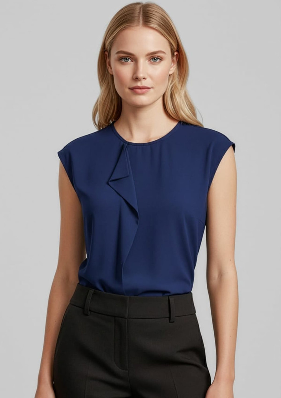 A women's navy top featuring a stylish ruffled design and cap sleeves, paired with black trousers.