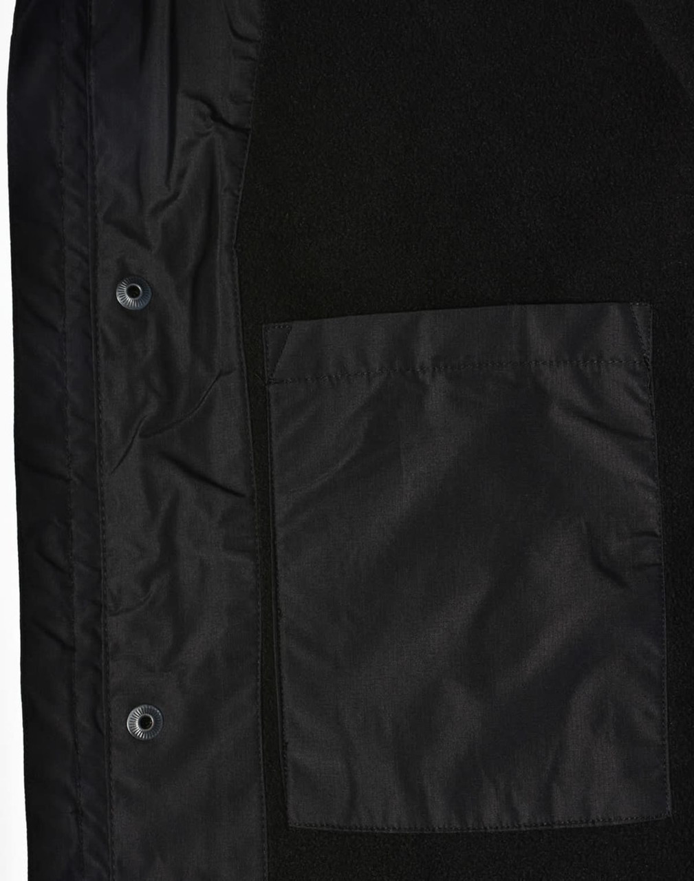 A unisex black jacket featuring a smooth fabric and a patch pocket. It includes snaps for closure and a logo.