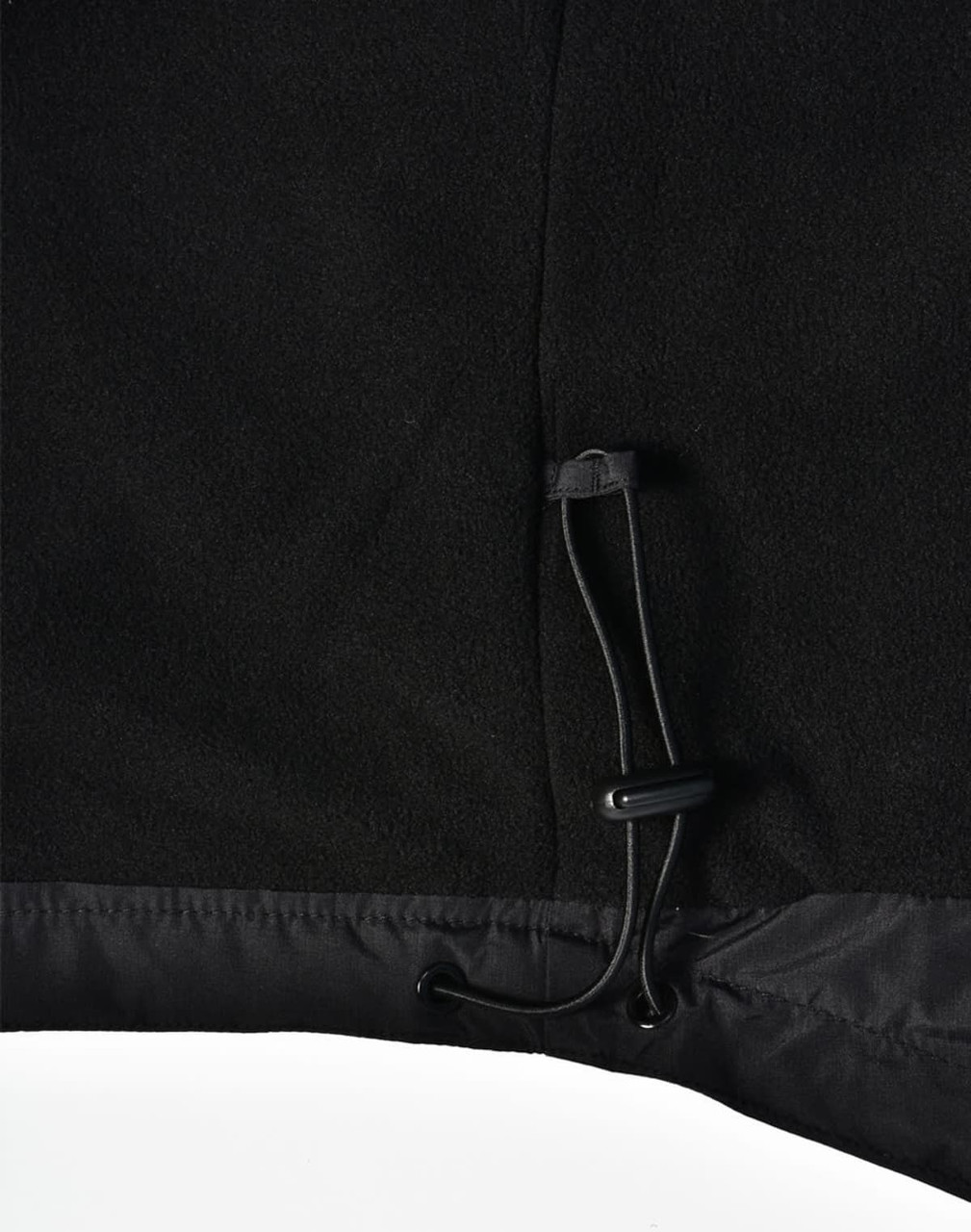 A close-up of a black unisex jacket featuring a pull cord at the hem, with a soft textured finish.