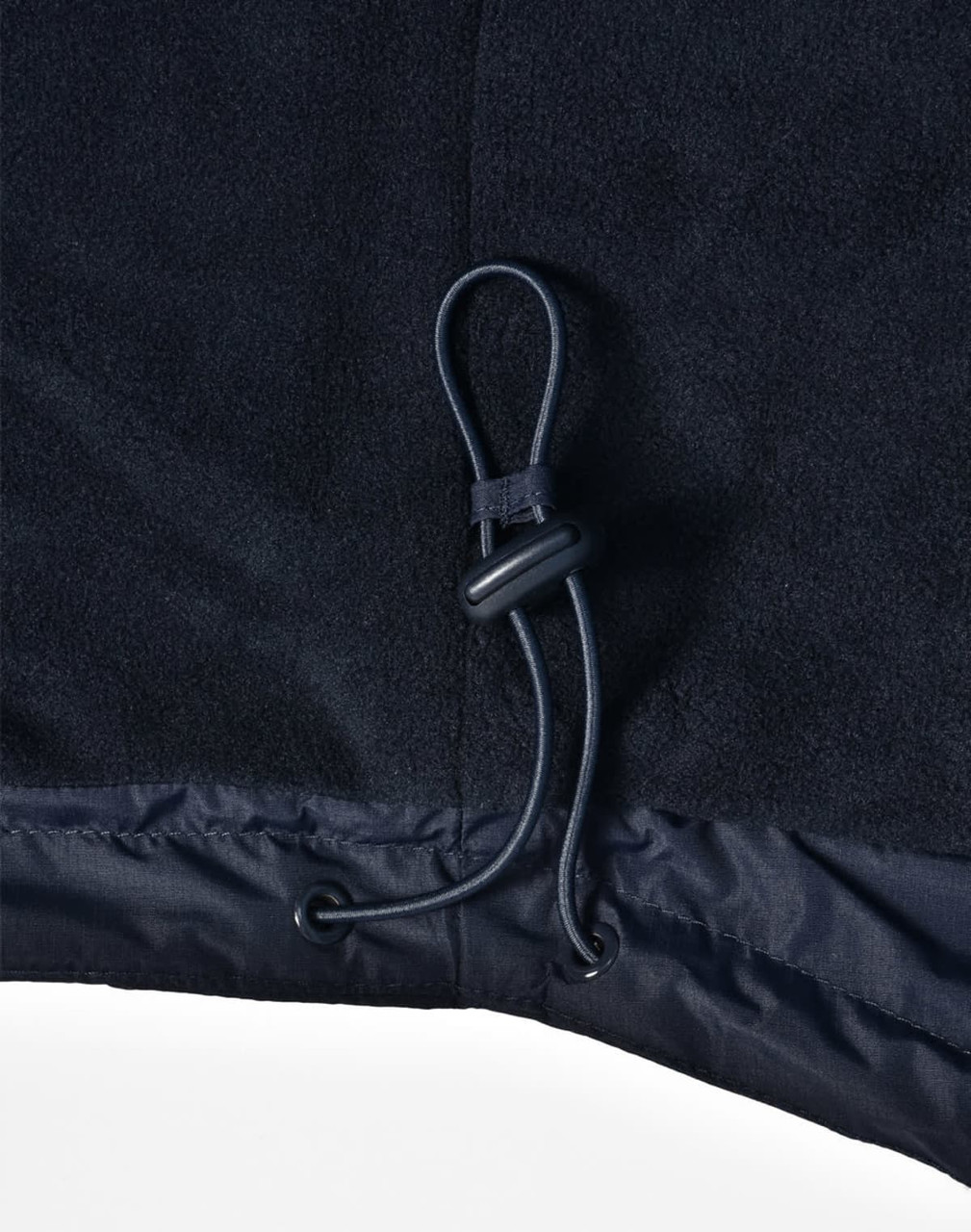A close-up of a navy unisex jacket featuring a drawstring at the hem and a smooth fabric texture.