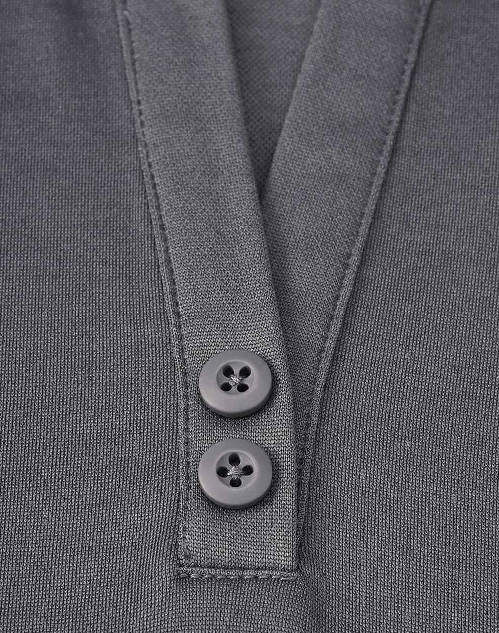 A close-up of a grey polo shirt featuring a placket with two black buttons and a sustainable fabric blend.