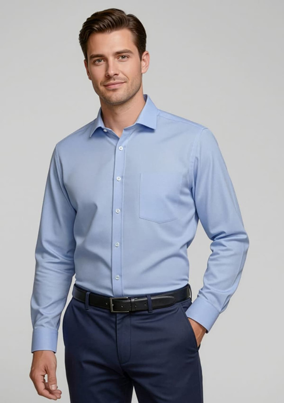 A light blue button-up shirt with long sleeves, featuring a single chest pocket and a collar, worn by a model.