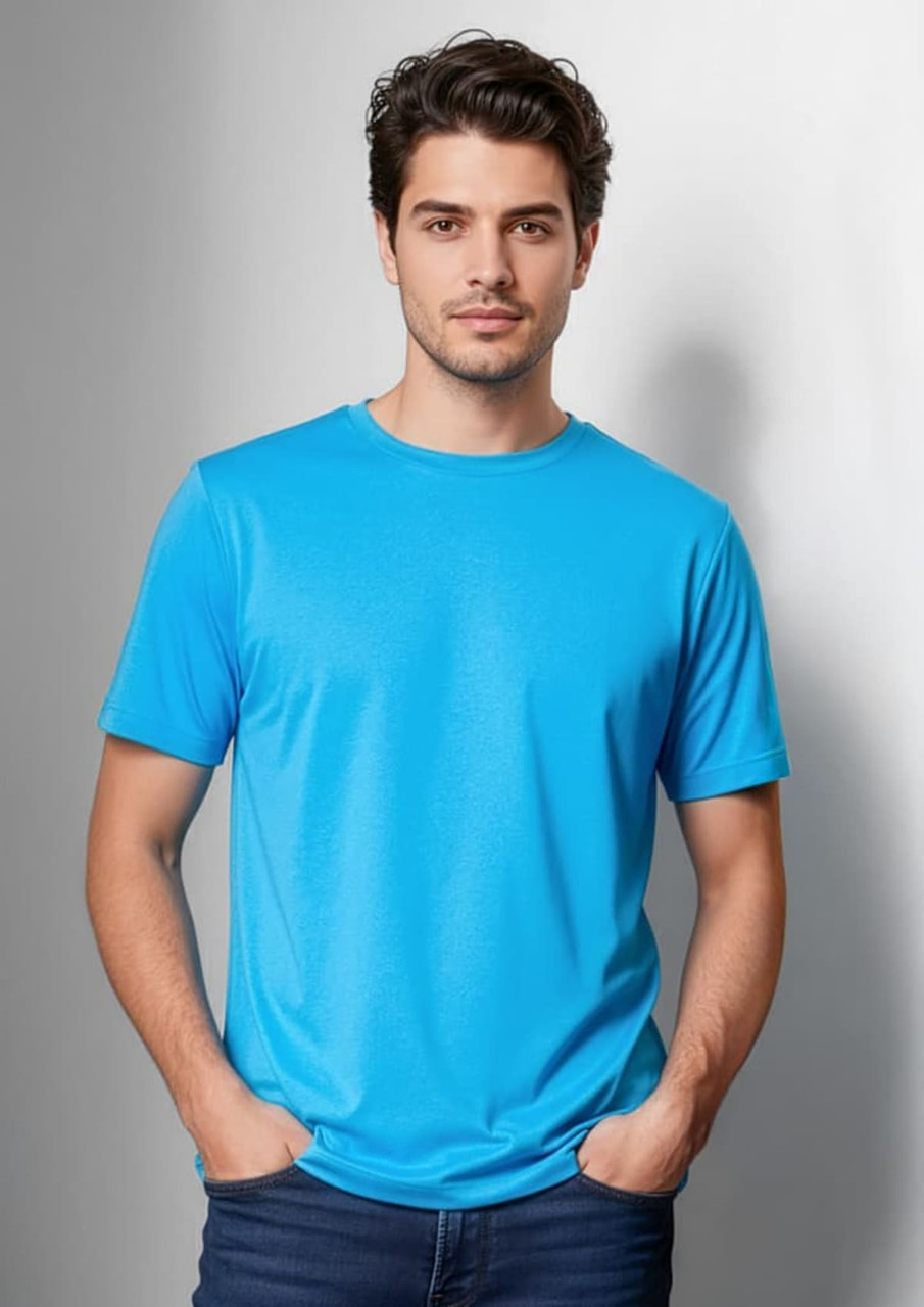 A blue short sleeve men's T-shirt, featuring a round neck and a smooth fabric finish. The model stands casually, hands in pockets.