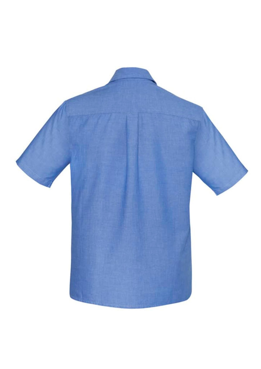A blue men's chambray short sleeve shirt with a button-up design and a back yoke. Features a logo.