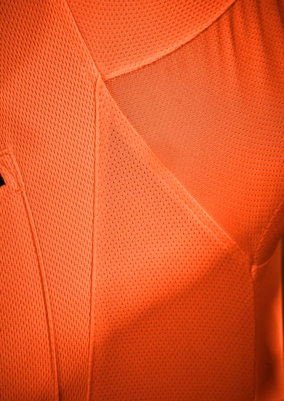 An orange short sleeve polo shirt with a textured fabric, featuring a logo on the chest.