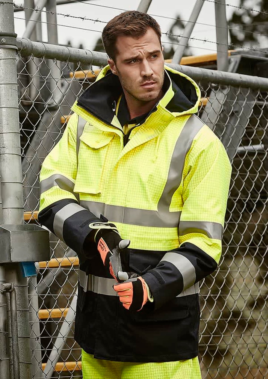 A man's high-visibility waterproof jacket in yellow and black with reflective strips, worn with gloves.