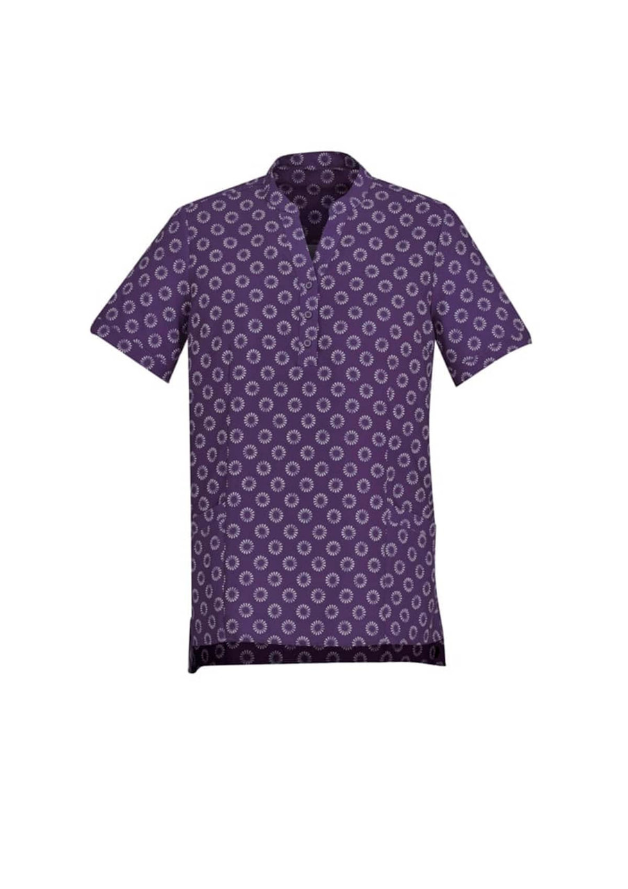 A purple tunic featuring a white daisy print, designed with short sleeves and a collar. It has pockets and a logo.
