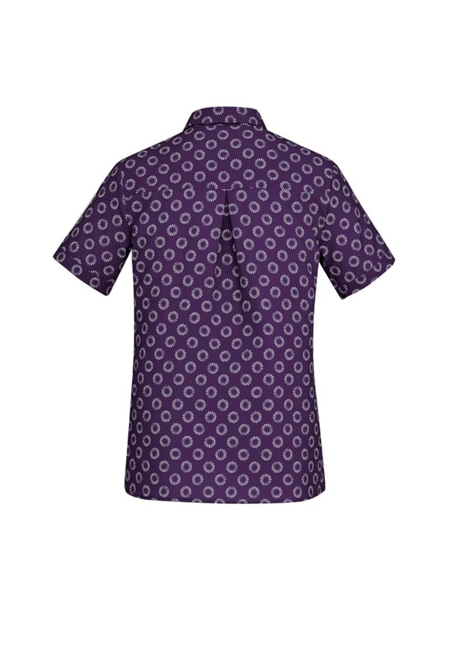 A short sleeve women's button-up shirt in purple with a daisy print pattern, featuring a subtle logo on the back.