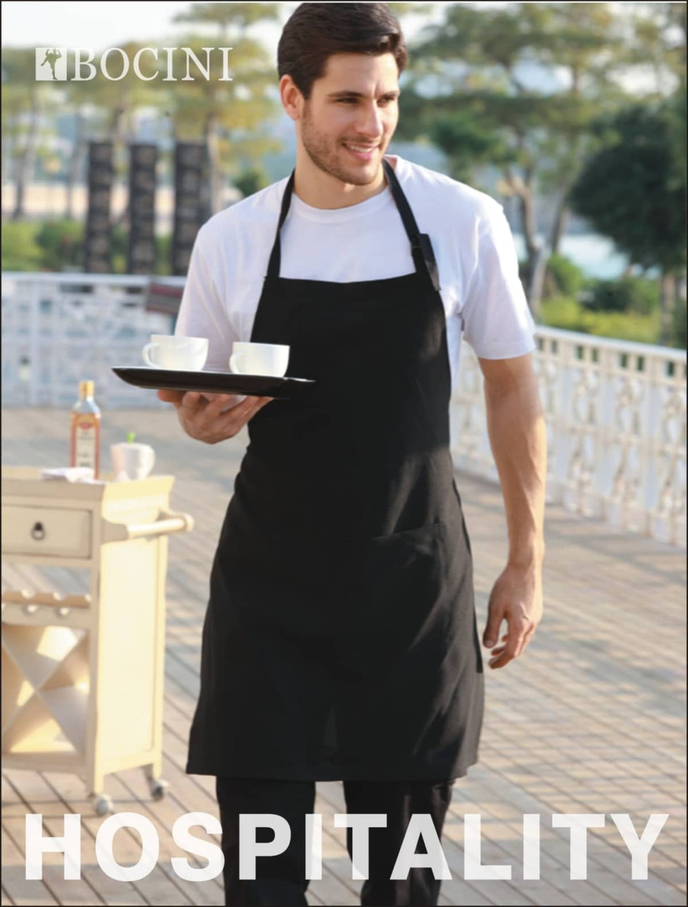 A black cotton drill full bib apron without pockets, worn by a man holding a tray with cups.