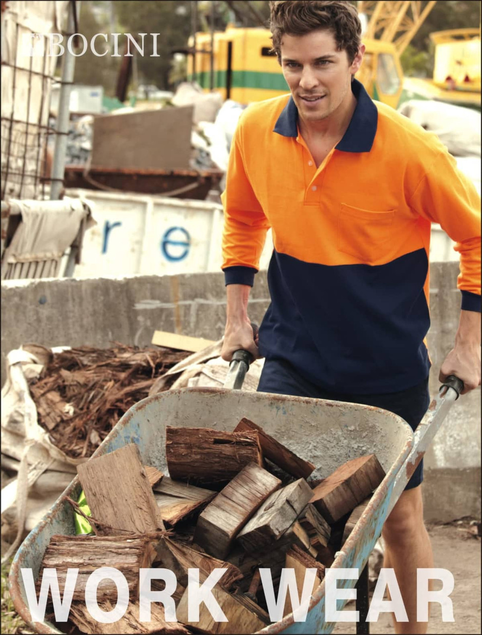 A man in an orange and navy long-sleeve polo shirt pushes a wheelbarrow filled with timber at a worksite.