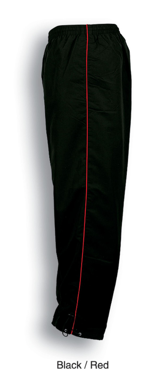 Unisex track suit pants in black with red piping, featuring an elastic waistband. Includes a logo design.