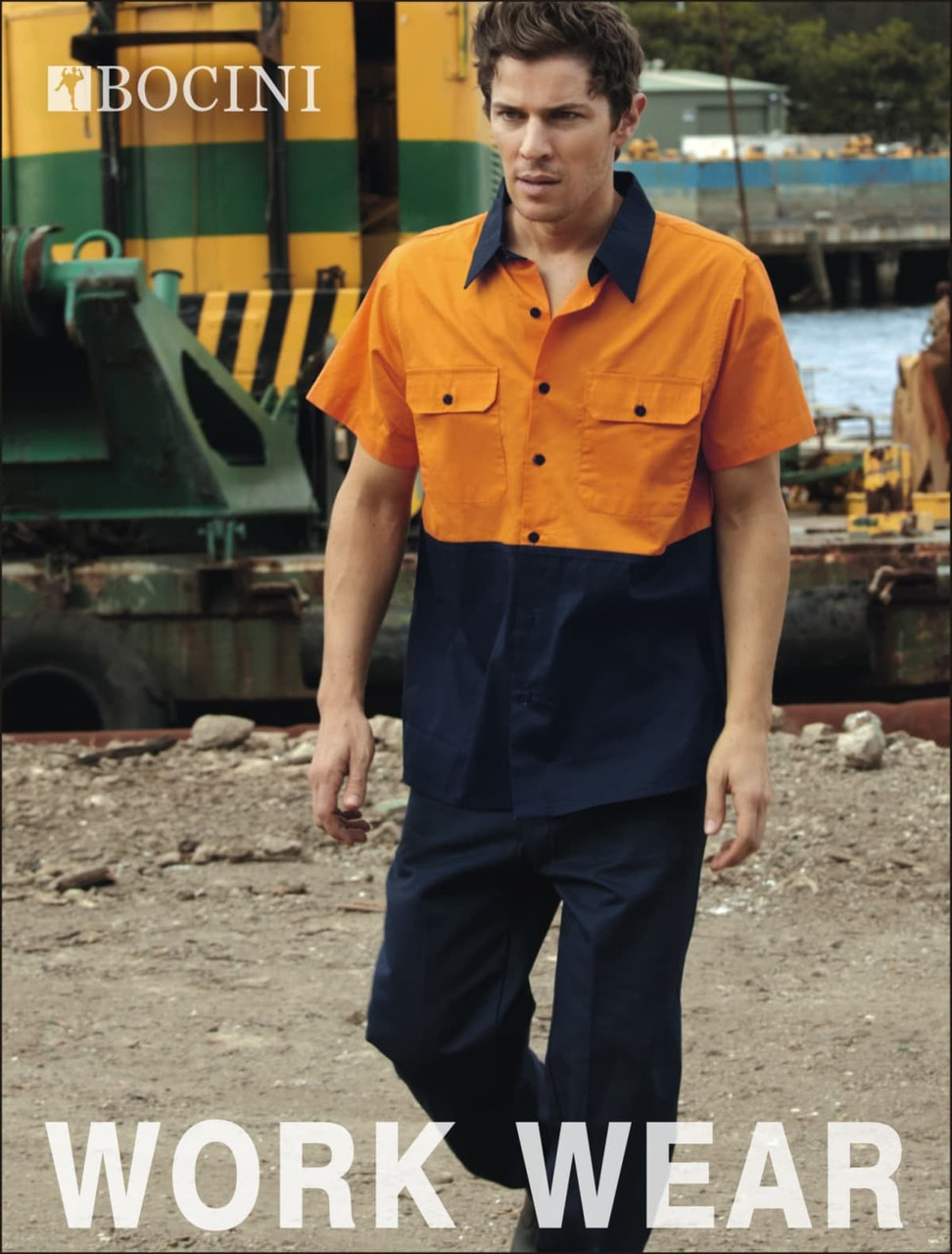 A man wears a short-sleeve, hi-vis cotton twill work shirt in orange and navy blue, featuring a logo.