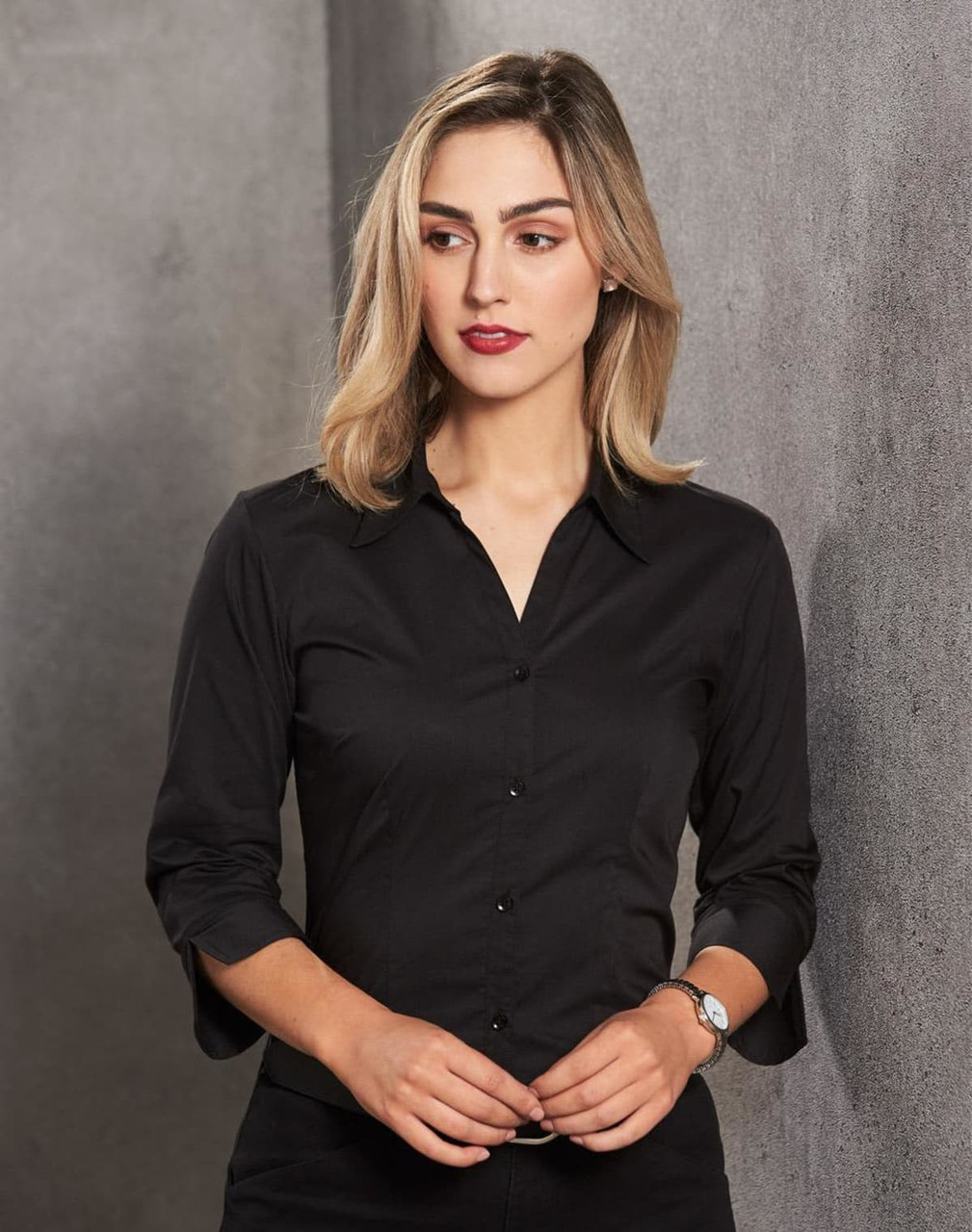 A black women's button-up shirt with 3/4 sleeves, featuring a collar and a logo.
