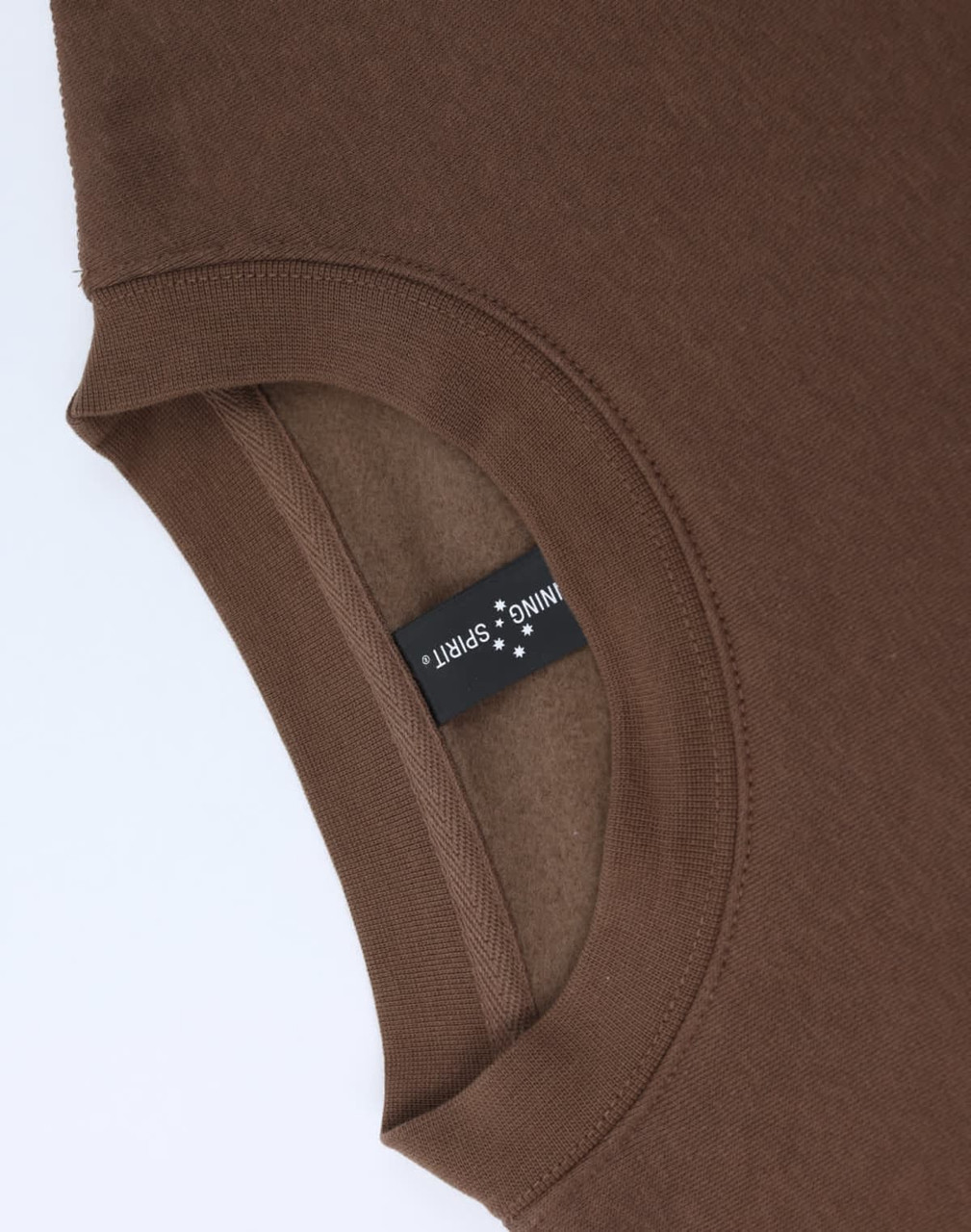 A brown crew fleece jumper with a round neckline, featuring an inner label and a smooth texture.