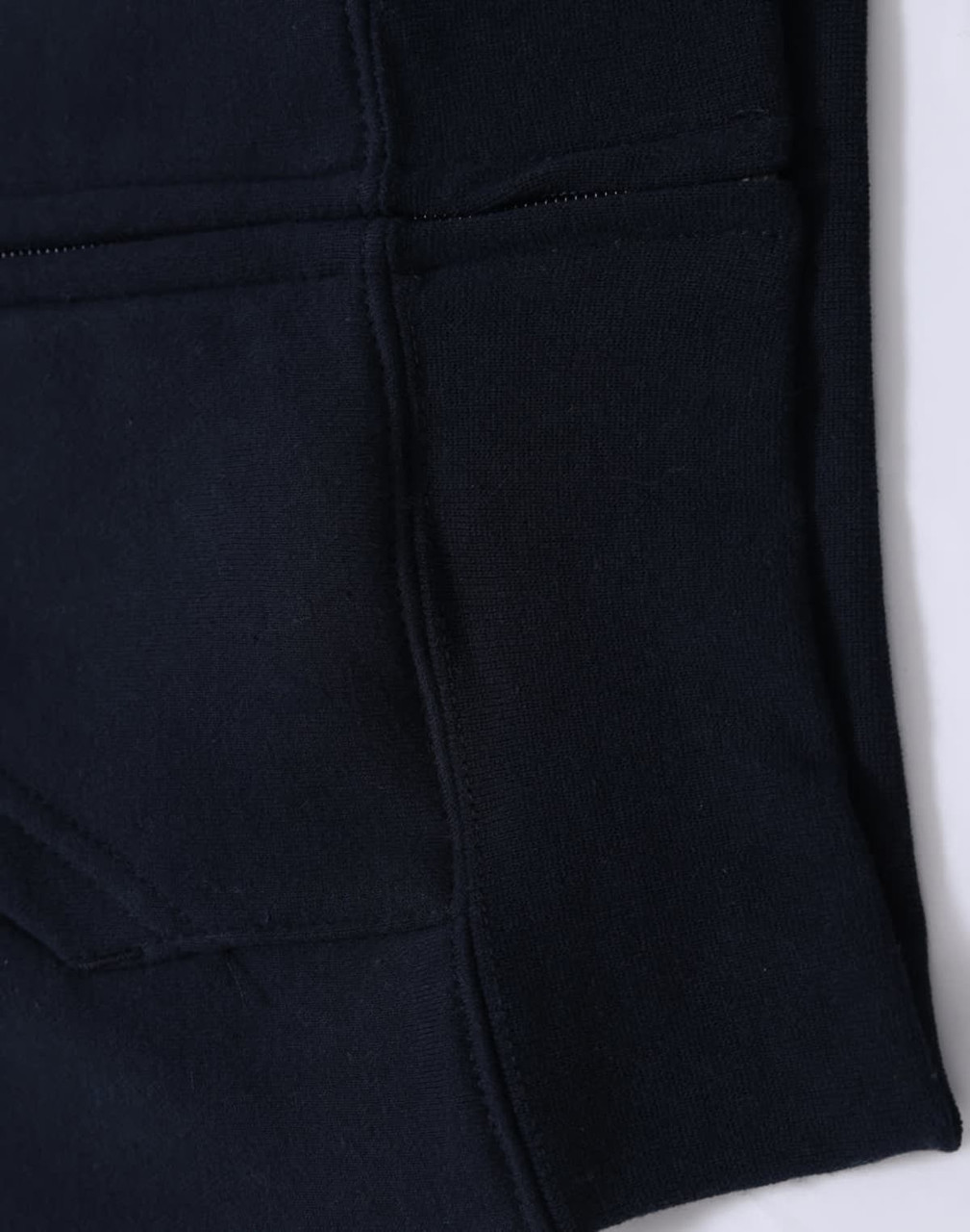 A black kid's full-zip fleecy hoodie featuring a kangaroo pocket and a smooth texture. It has a logo detail.
