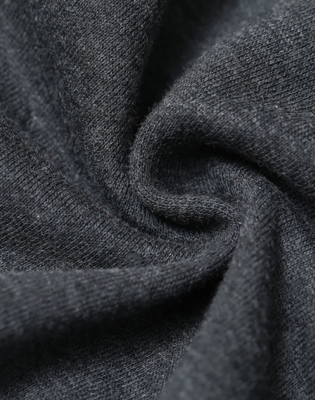 A close-up of dark grey fabric showcasing a soft, fleecy texture with a slight swirl pattern.