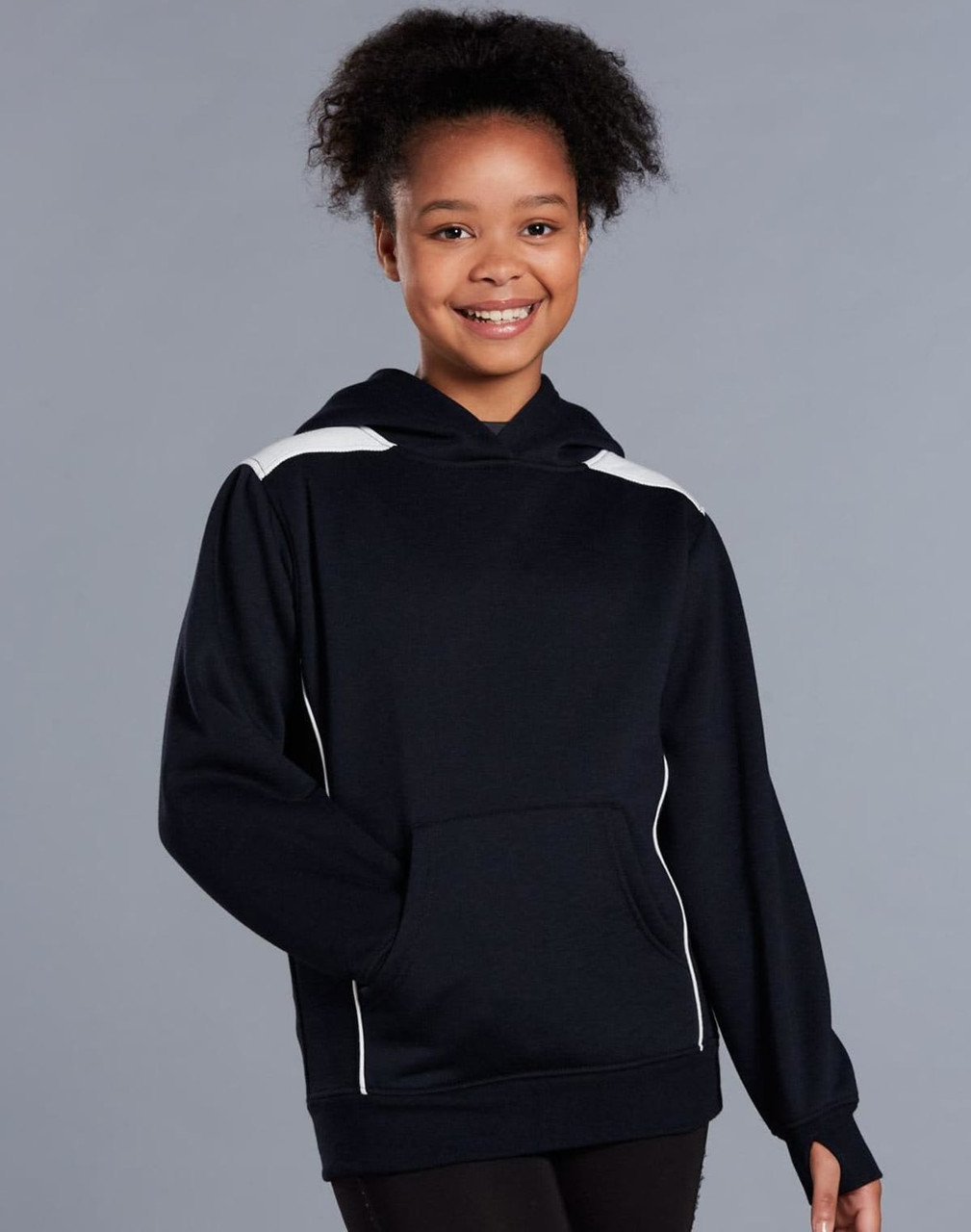 A young girl wearing a navy blue hoodie with white contrast detailing and a kangaroo pocket.
