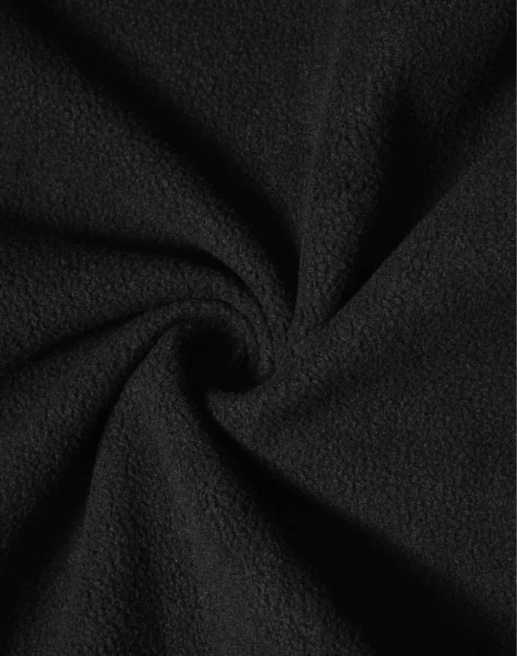A close-up of soft black fabric showcasing a plush texture, suitable for high-tech softshell jackets.
