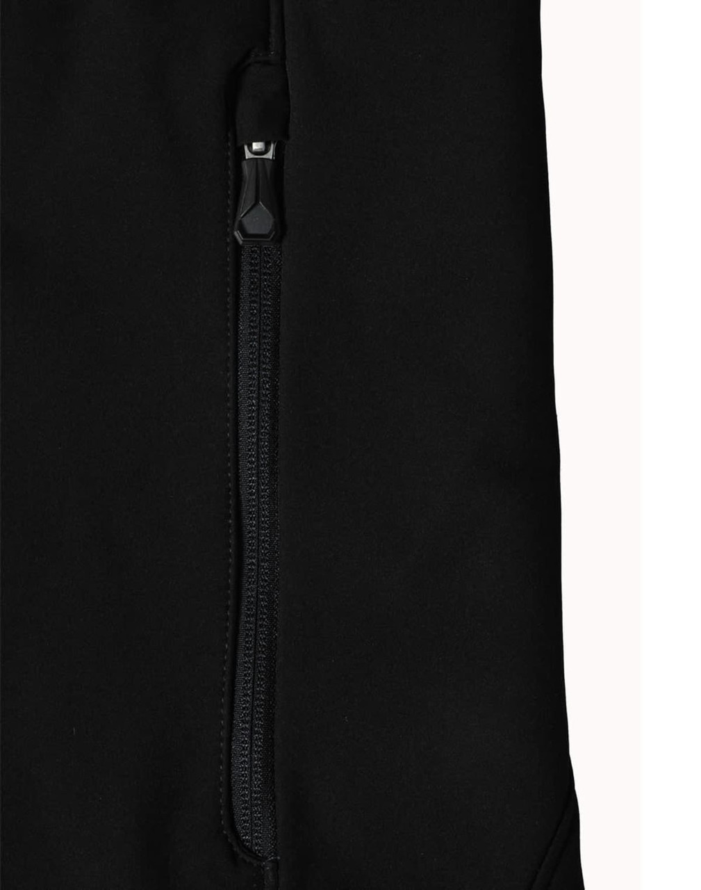 A close-up of a black softshell jacket featuring a zipped pocket and a branded logo.