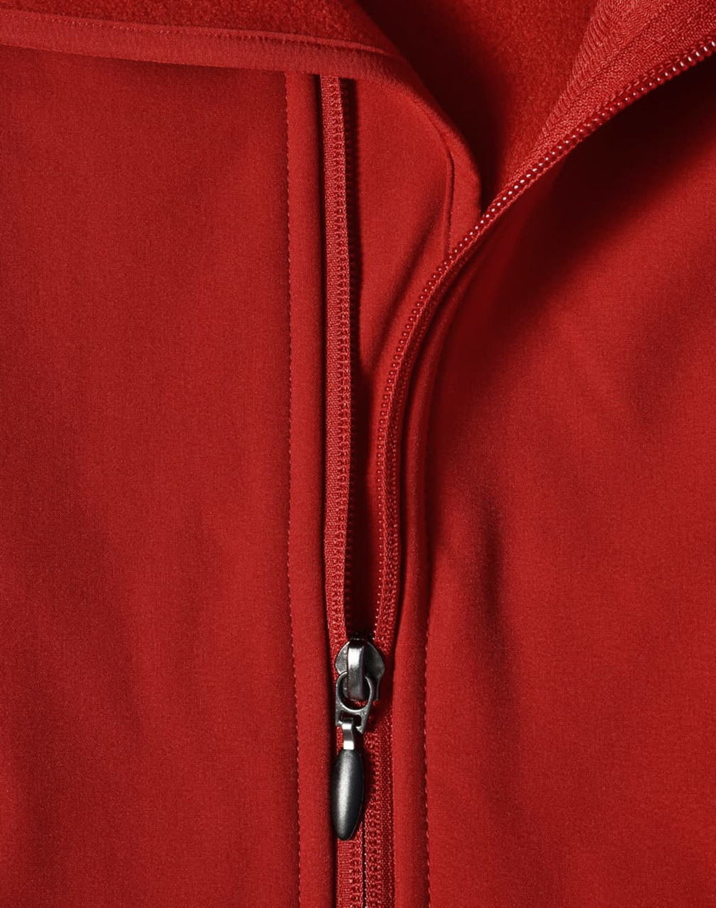 A red softshell vest with a zippered front and a fleece interior, featuring a logo.