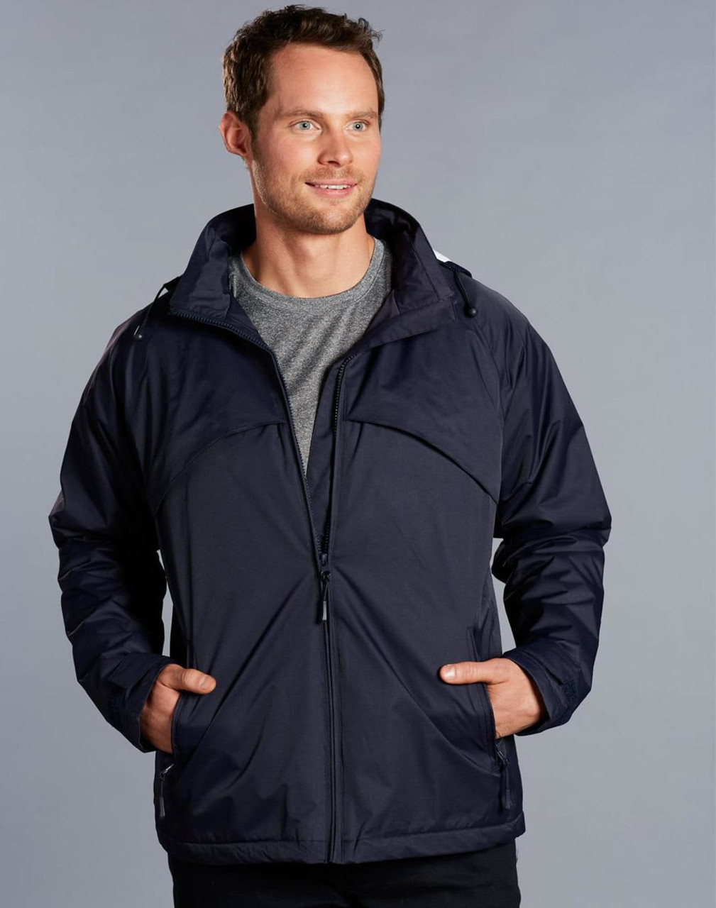 A men's navy chalet jacket with a zip front, featuring a hood and two side pockets, worn by a model.