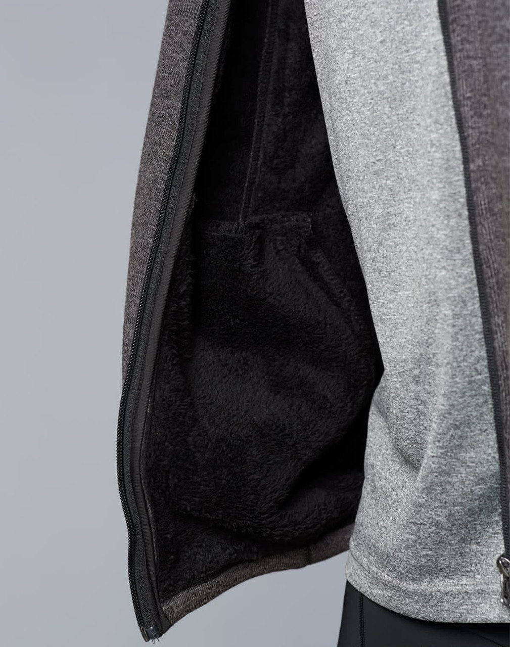 A men's grey bonded fleece jacket displaying a soft, fleece-lined interior with a pocket. It has a logo on the exterior.