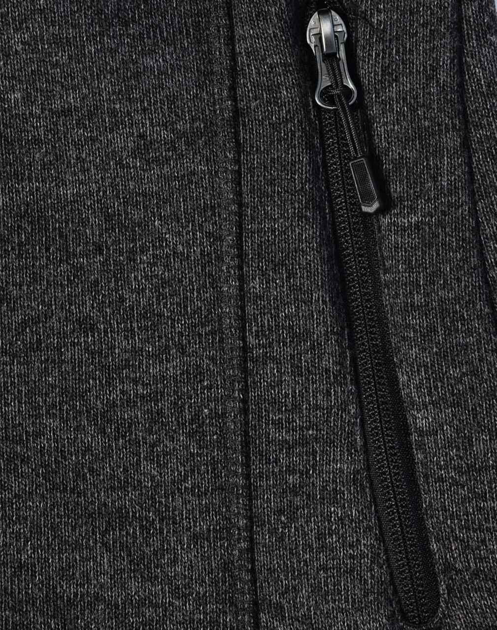 A dark grey fleece jacket with a zippered front and soft texture, featuring a small logo on the fabric.
