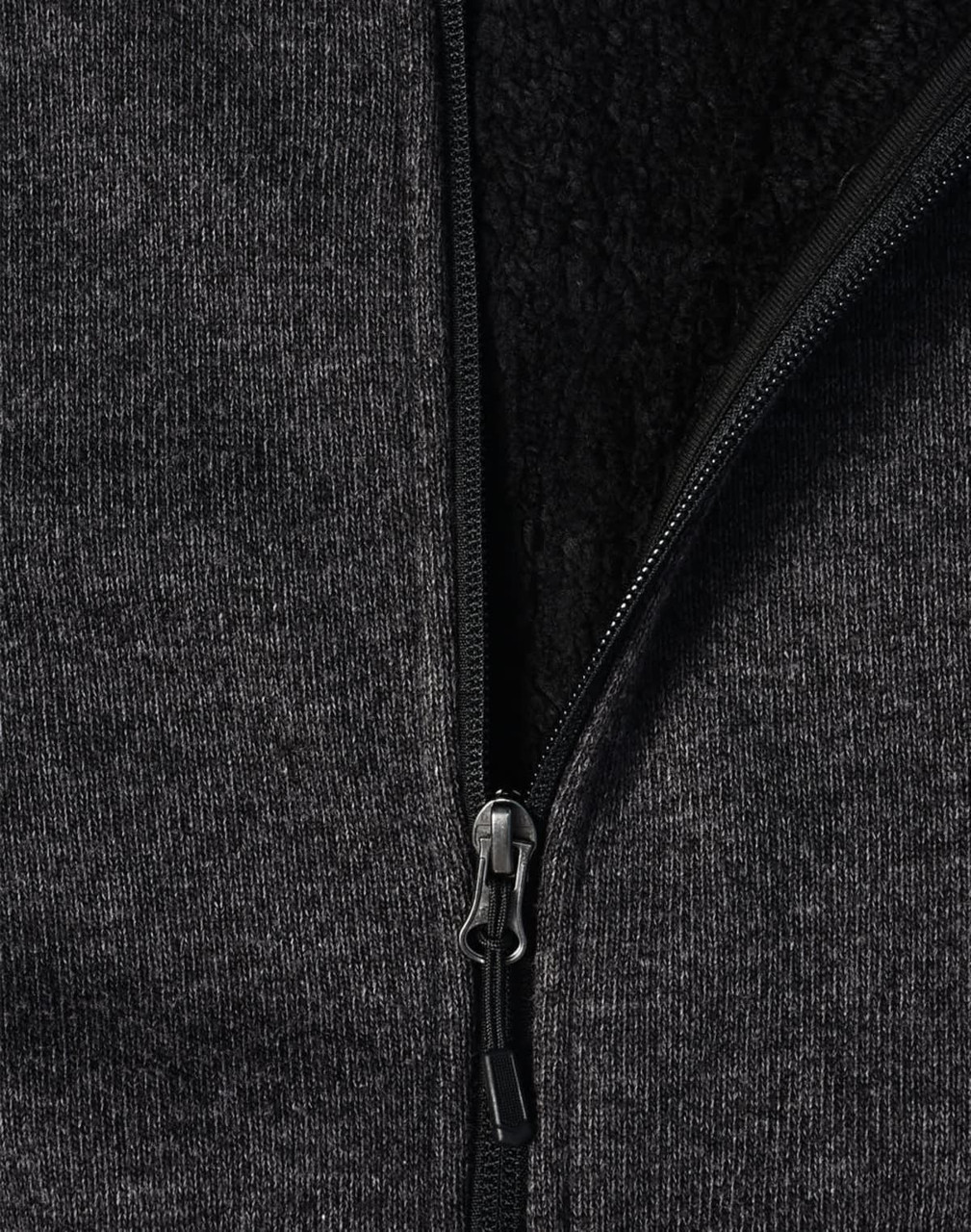 A ladies' grey bonded fleece jacket featuring a zip closure and soft inner lining. It includes a logo on the fabric.