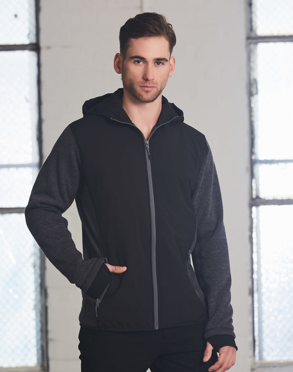 A men's jacket featuring a heather sleeve, quilted body, with a hood in black and grey tones. Includes a logo.