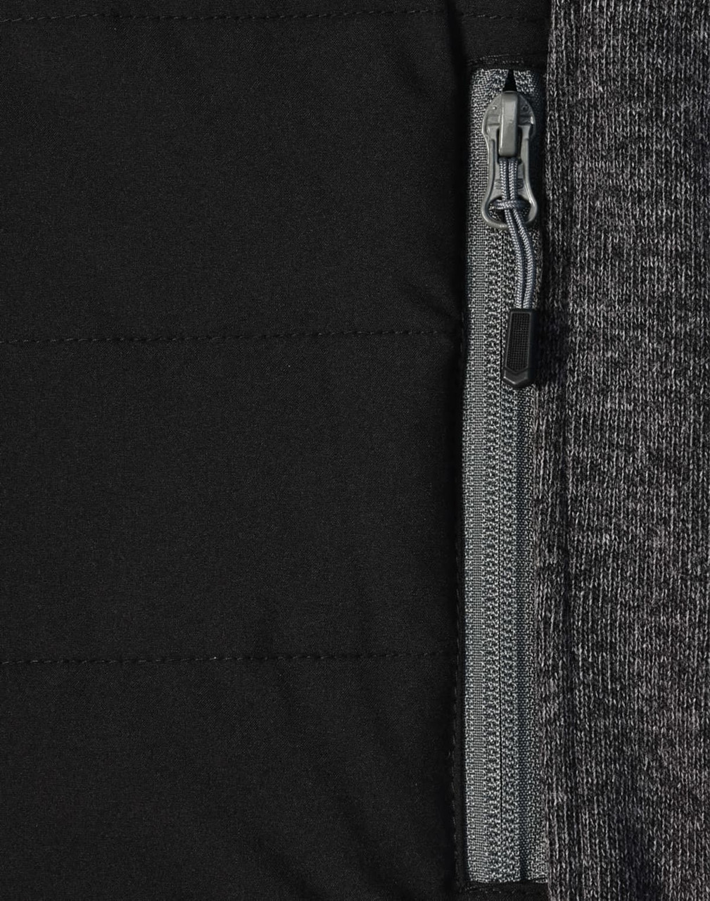 A close-up of a men's jacket featuring a heather sleeve and quilted black body with a zip pocket.