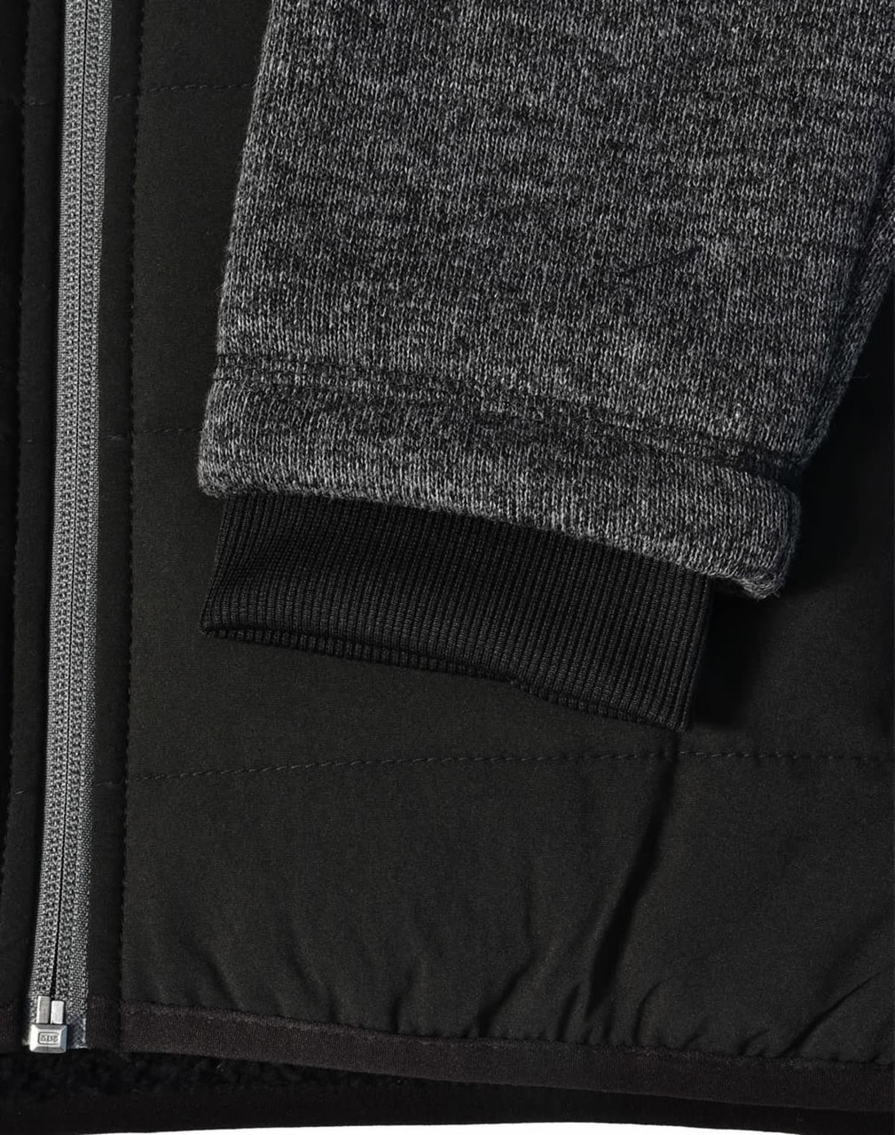 A black quilted jacket featuring heather grey sleeves and a ribbed cuff, with a side zipper and fabric texture detail.