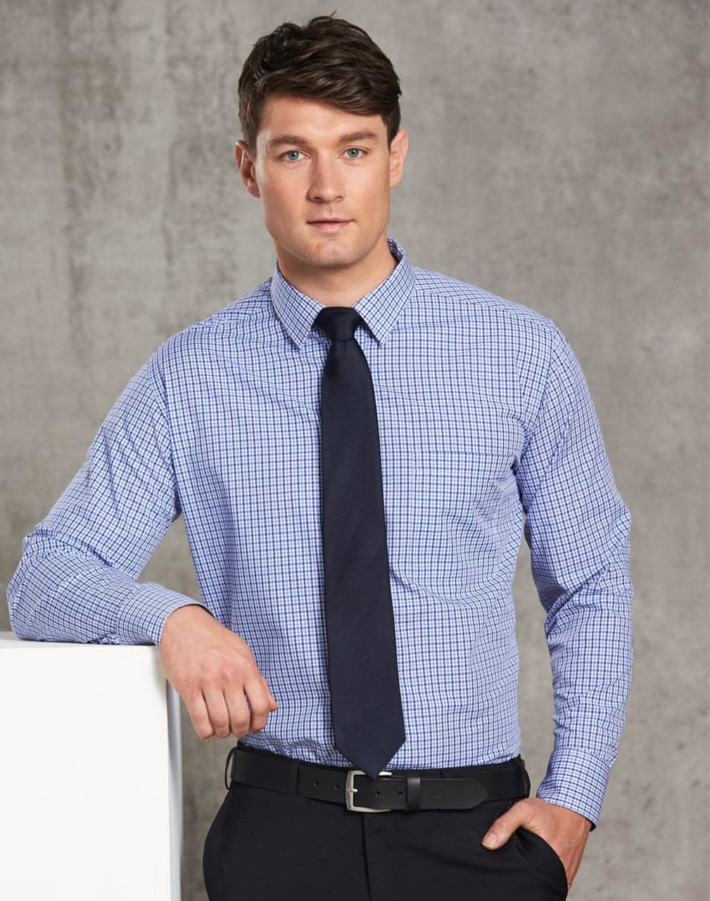 A two-tone blue and white check long-sleeve shirt displayed on a male model, featuring a dark tie and belt.