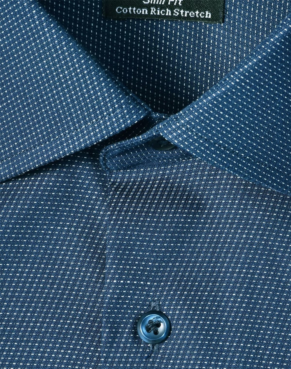 A close-up of a blue pin dot stretch button-up shirt featuring a patterned fabric and a branded tag.